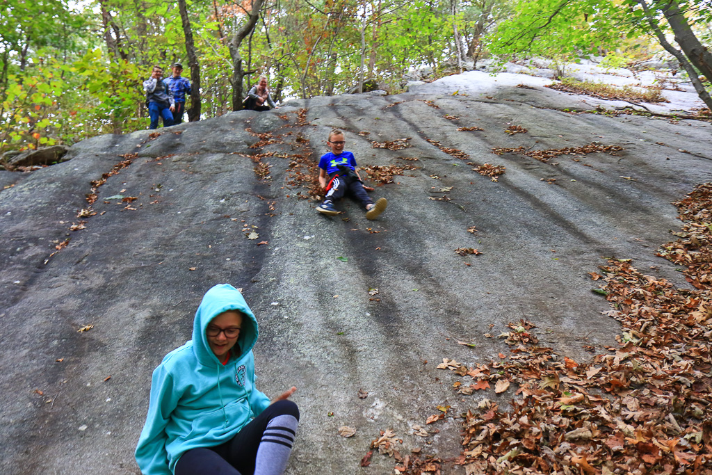 Cam sliding down a sandstone slab - McAfee Knob